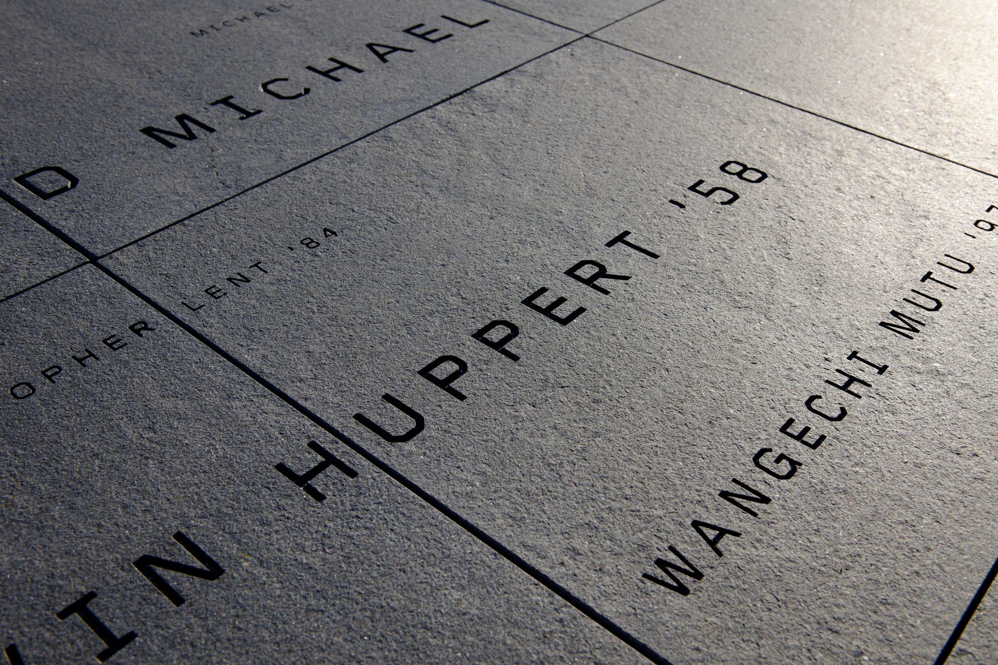 Donor signage on the roof terrace appears as a constellation of names engraved in granite.